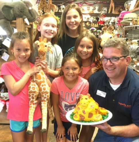 group of young females with director in Topeka Zoo gift shop