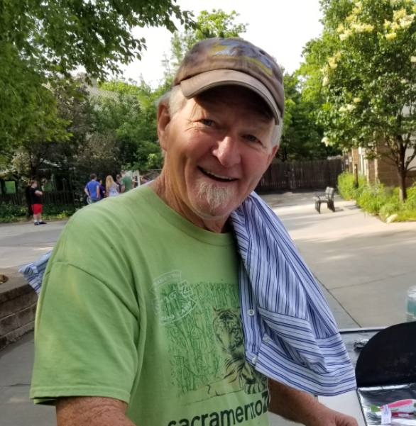 male with green tshirt and baseball cap at Topeka Zoo